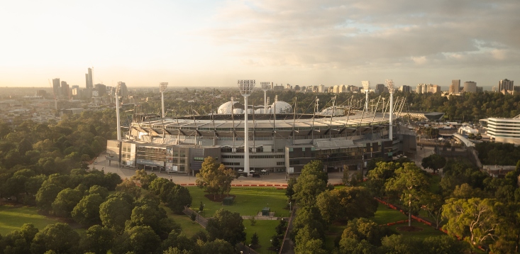 Footy fans queue “for miles” at the MCG, as hospitality staff shortages bite