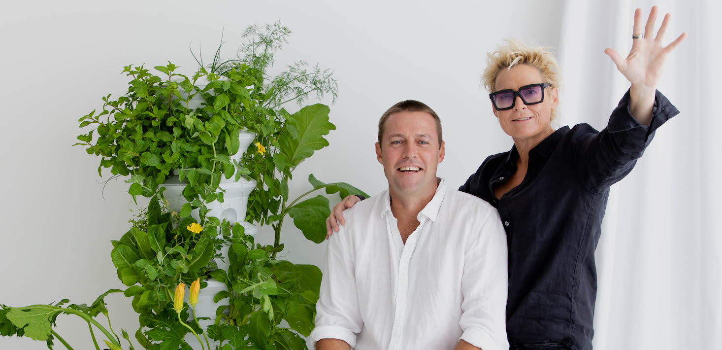 Airgarden founders Tom Bauer and Prue Bauer photographed next to aeroponic plants.